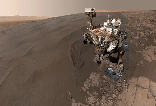 This self-portrait of NASA's Curiosity Mars rover shows the vehicle at "Namib Dune," where the rover's activities included scuffing into the dune with a wheel and scooping samples of sand for laboratory analysis. The scene combines 57 images taken on Jan. 19, 2016, during the 1,228th Martian day, or sol, of Curiosity's work on Mars. The camera used for this is the Mars Hand Lens Imager (MAHLI) at the end of the rover's robotic arm. Namib Dune is part of the dark-sand "Bagnold Dune Field" along the northwestern flank of Mount Sharp. Images taken from orbit have shown that dunes in the Bagnold field move as much as about 3 feet (1 meter) per Earth year. (NASA / JPL-Caltech / MSSS)