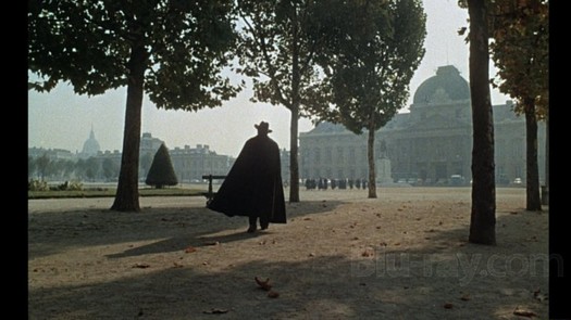 A silhouette of Orson Welles in a park.