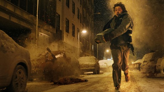 Hero running through street with package as bodies crash into the cars around him.