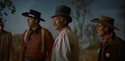 Three and a half men in hats, looking westward.