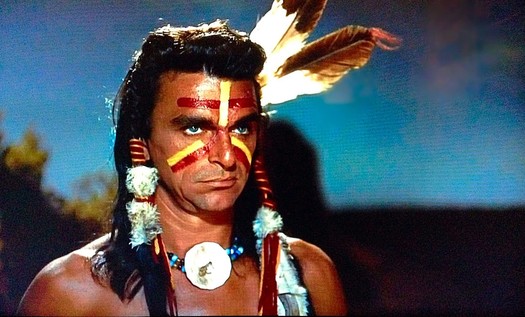 A German man with blue eyes dressed as an Amerind